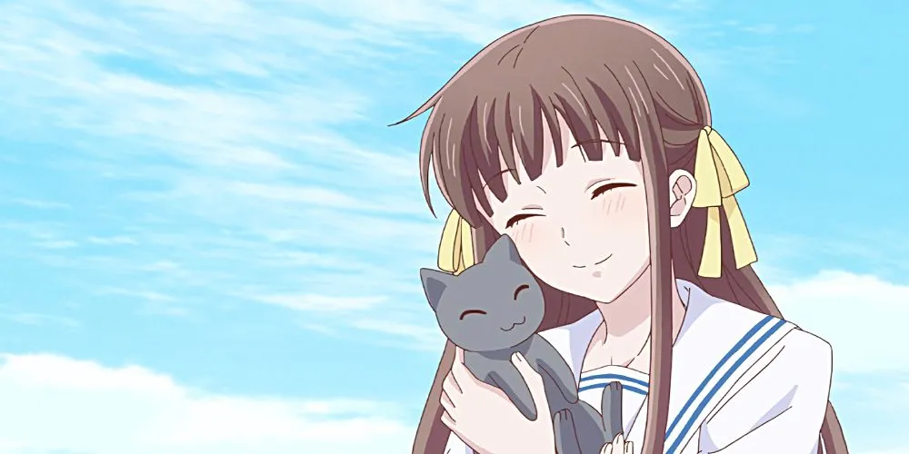 Tohru Honda từ Fruits Basket với nụ cười ấm áp, người học cách chữa lành và chấp nhận tình yêu.