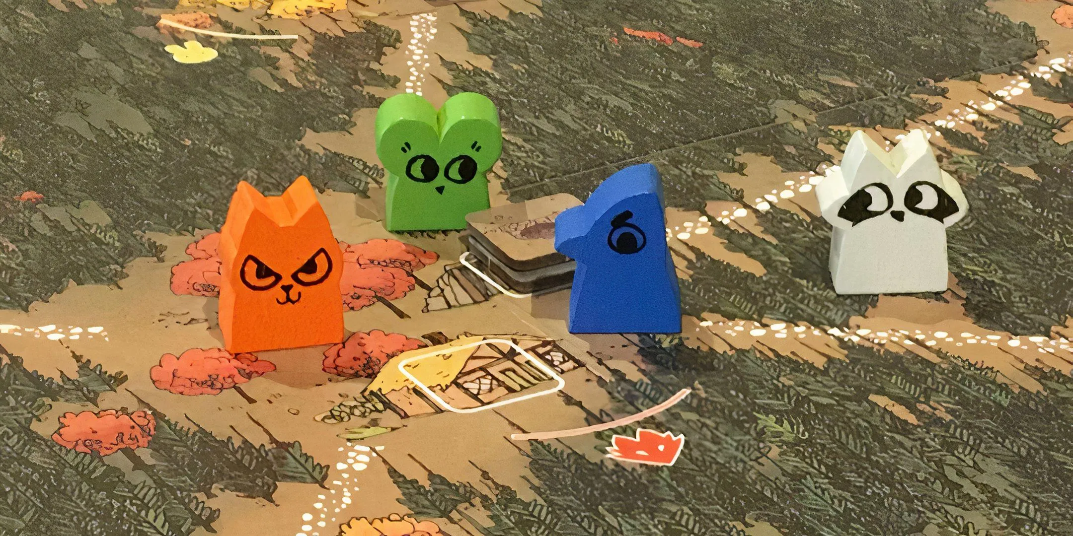 Bốn quân cờ gỗ hình động vật đại diện cho các phe phái trên bản đồ game Root, thể hiện sự đối đầu trong rừng và cuộc chiến giành quyền kiểm soát.