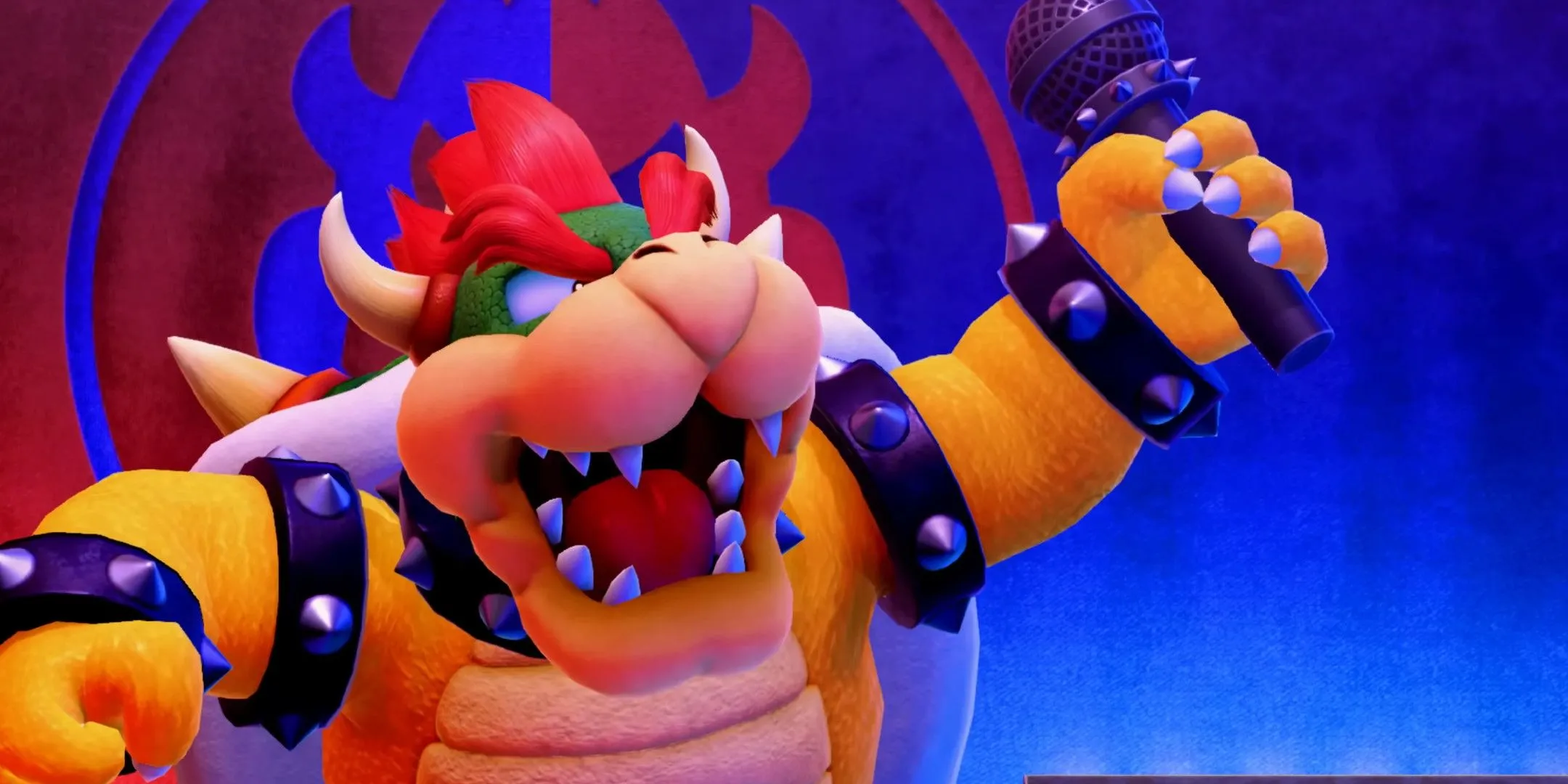 Bowser trên sân khấu với micro trong tay, biểu tượng của chiến thuật bắt cóc công chúa trong Mario.