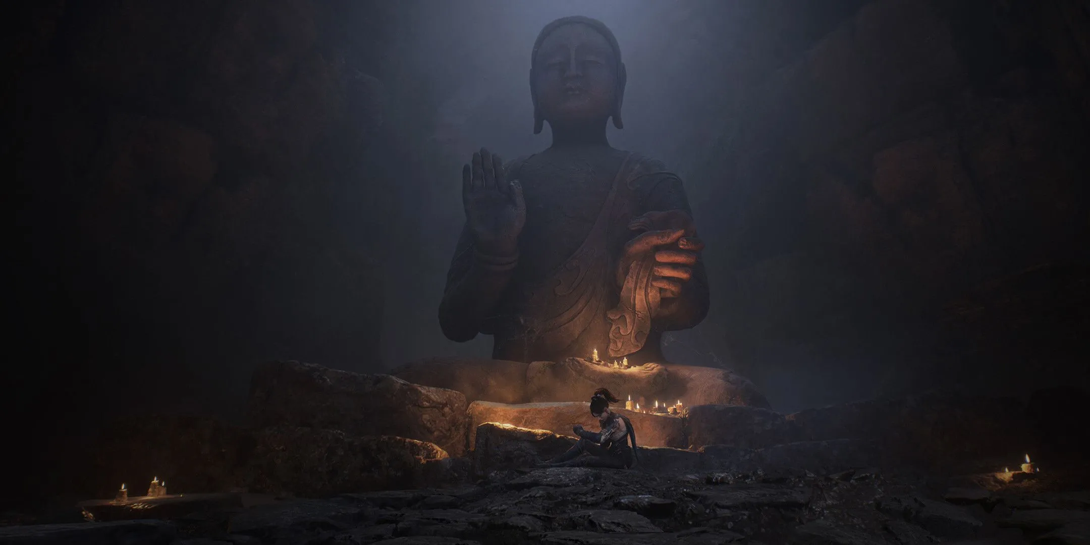 Nữ nhân vật ngồi tĩnh lặng dưới chân tượng Phật lớn, hình ảnh trong cốt truyện Wuchang: Fallen Feathers.
